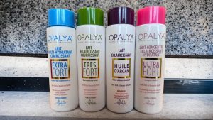 Four Opalya skincare bottles showing different product formulations with colored caps
